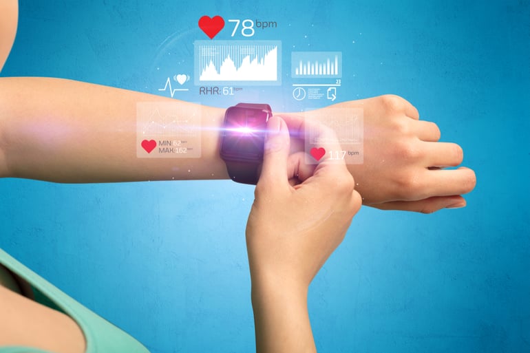 Female hand with smartwatch and health application icons nearby.